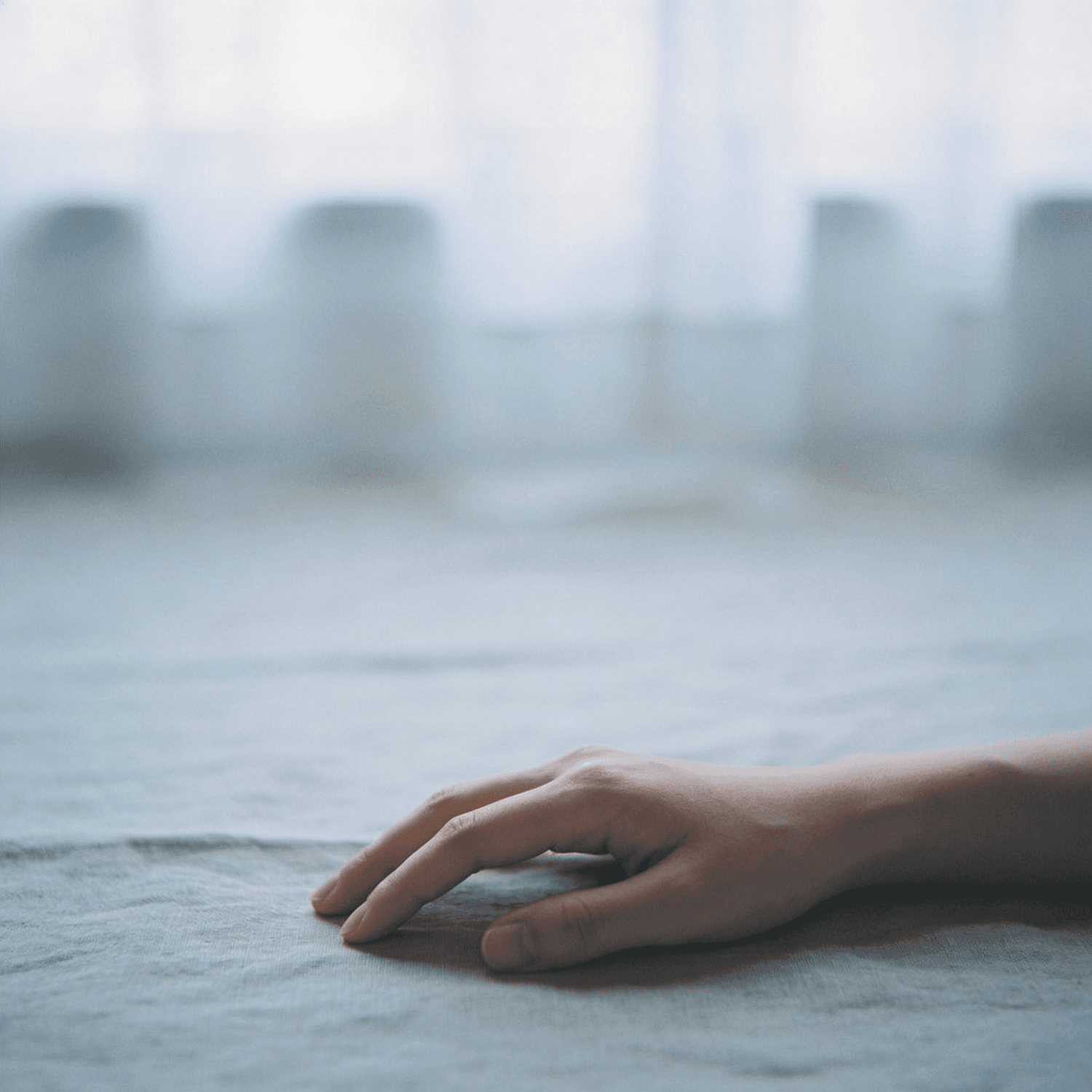A hand resting on soft, freshly finished fabric